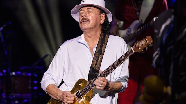 US legendary guitarist, Carlos Santan Picture: GETTY IMAGESa Carlos Santana passes out on stage